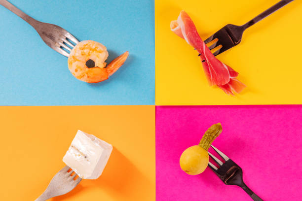 Cocktail or wine snacks on a colorful background, overhead flat lay shot
