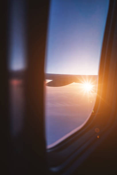 istock Top view from inside window airplane of sunset sky and wing 1310862852