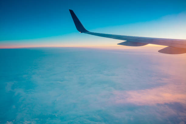 istock Top view from inside window airplane of a sunset sky and wing 1310862859