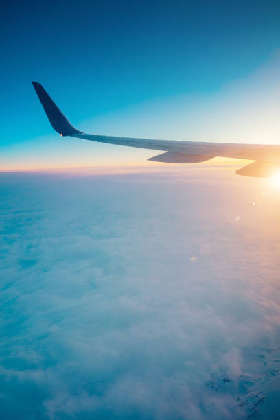 istock Top view from inside window airplane of a sunset sky and wing 1310862862