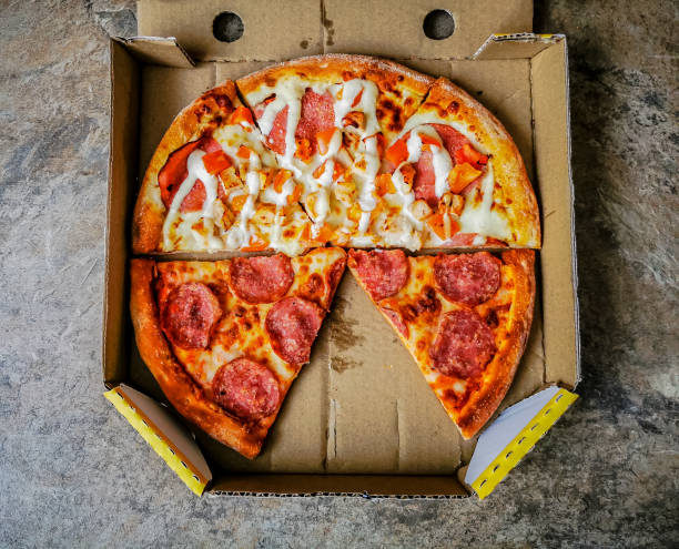 istock Pieces of two different pizza slices in a cardboard pizza box 1310862897