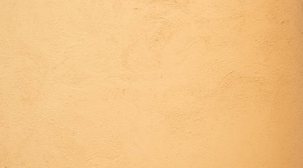 istock Yellow orange Beige painted stucco wall construction 1310863078