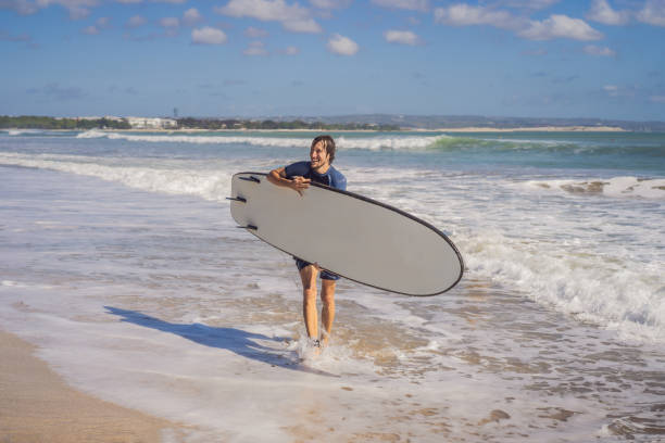 istock Surfer with his surfboard running to the waves 1310863177