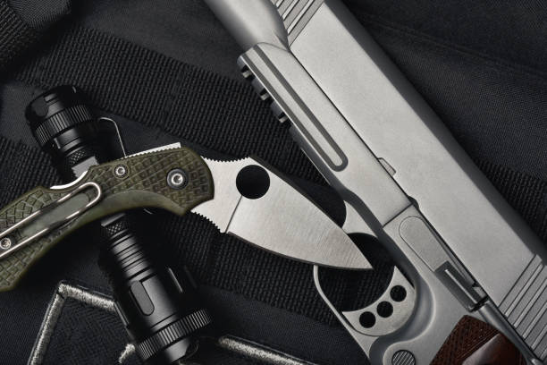 istock Weapons and military equipment for army, Semi-automatic handgun .45 pistol tactical flash light and pocket army knife. 1310863236