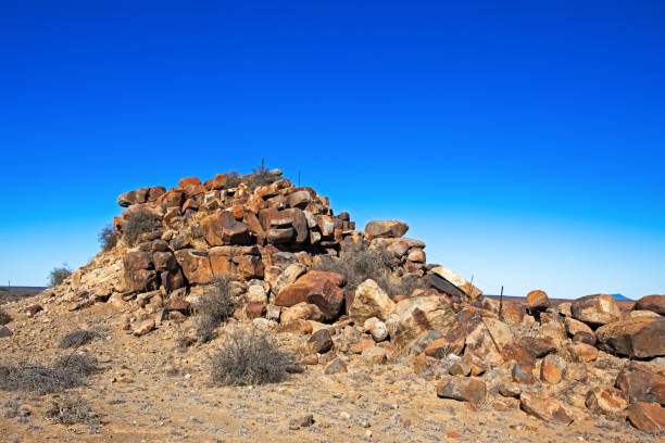 Small rocky hill with large boulders and fence in in Nama Karoo in Northern Cape, South Africa