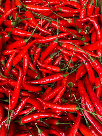 Basket full of red chili peppers on a street market in Catania, Sicily.
