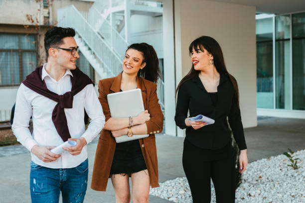 istock Group o university students carrying laptops and papers 1310865612