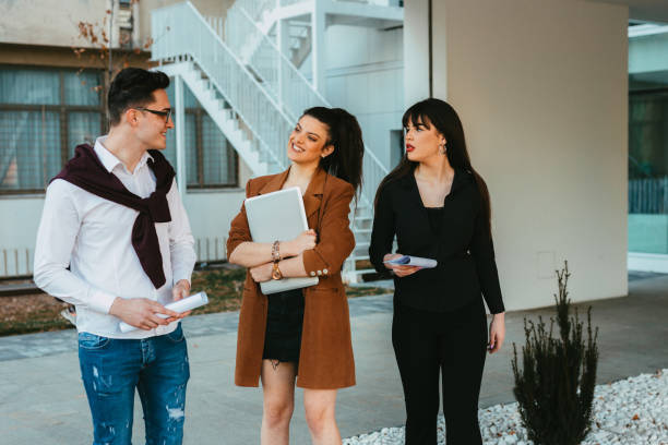 istock Group o university students carrying laptops and papers 1310865617