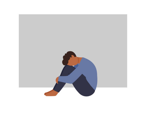 A lonely  african man sitting and hugging his knees. Young depressed male character. Sad thoughts. Depressed man concept. Vector illustration in flat style vector art illustration
