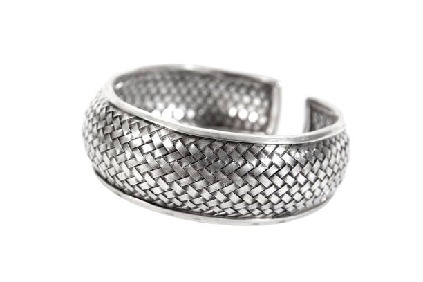 istock Silver bracelet isolated on white background. Thick silver bracelet or armlet with weave pattern design isolated 1310867359