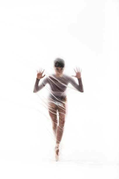 istock Graceful ballerina dancing with transparent nylon 1310869582