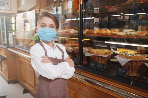 istock Young baker boy at parents bakery shop 1310870003