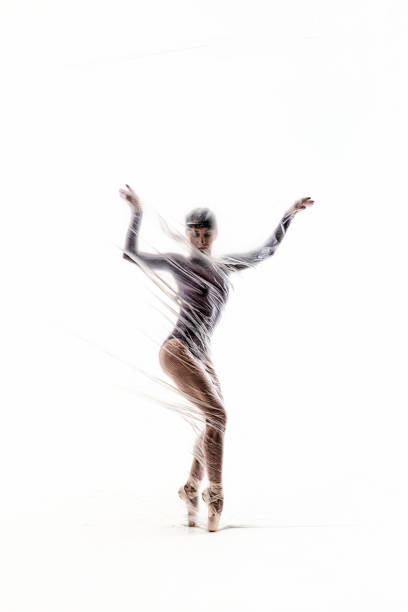 bailarina elegante bailando con nylon transparente - fantasy women blurred motion studio shot fotografías e imágenes de stock