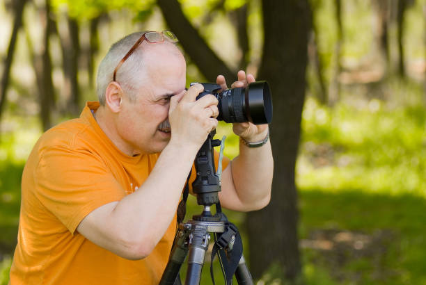 istock Enthusiastic photographer taking a photo outdoor. 1310870075