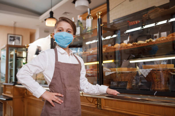 istock Young baker boy at parents bakery shop 1310870087