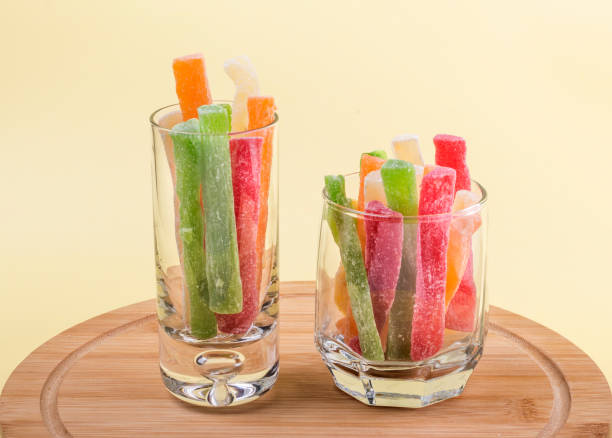 istock oriental sweets candied pineapple in two glasses on a yellow background 1310872696