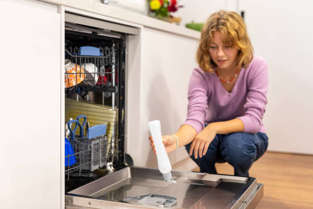 istock Teenage Girl Putting Using a Dishwasher 1310874044