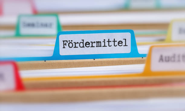 File folders with a tab labeled Funding in german - Fördermittel stock photo