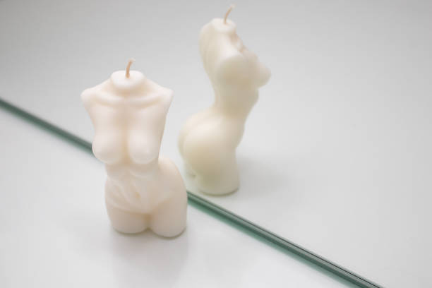 istock Candle figure of a human torso on a white background reflecteing in the mirror 1310874171