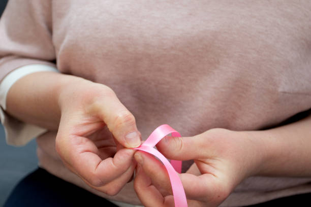 istock How to make silk ribbon rose flower. Step 2. Step by step photo instruction. Woman hands making decorative flower 1310875173