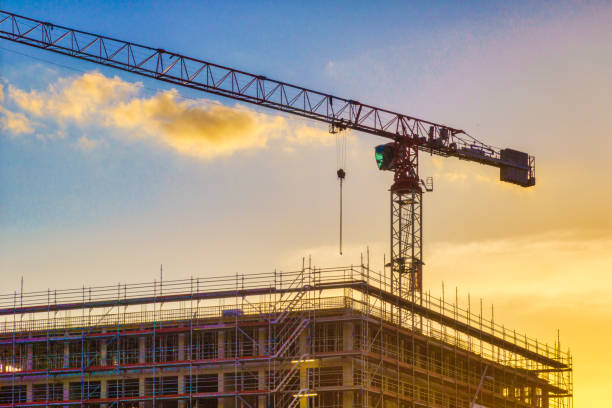 istock Construction site buildings and cranes in the backlight of the sunset 1310875206