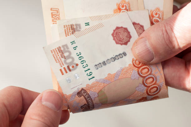 istock Man giving money five thousand ruble bills to his partner. 1310875264