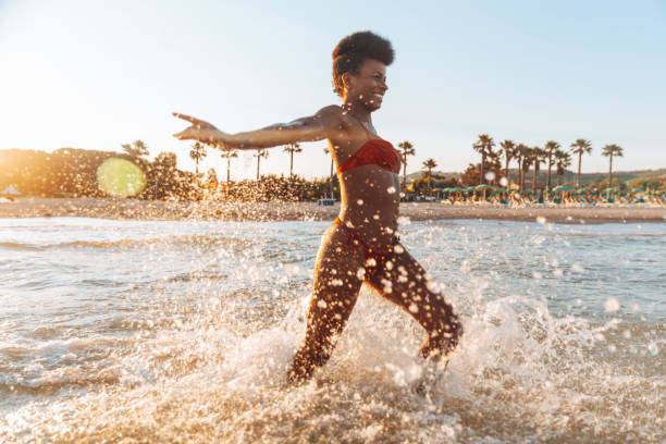 istock Woman enjoying a day at the beach 1310875859