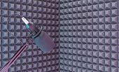 studio microphone over a recording corner with acoustic foam