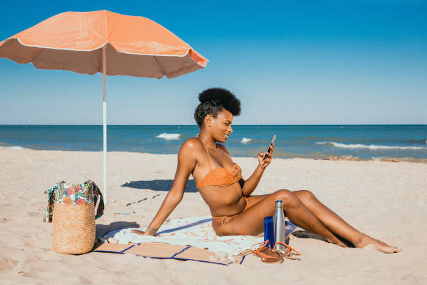 istock Woman enjoying summertime at the beach 1310876570