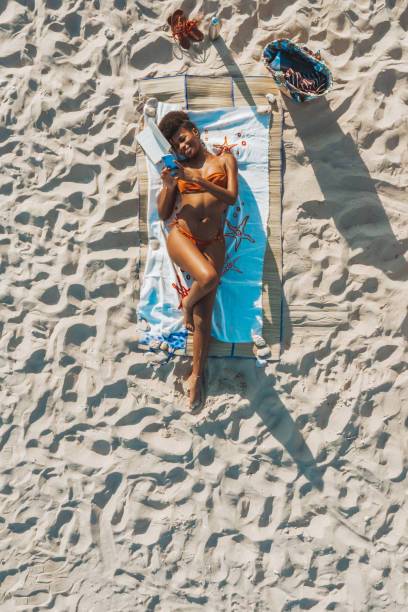 istock Woman enjoying summertime at the beach 1310876605