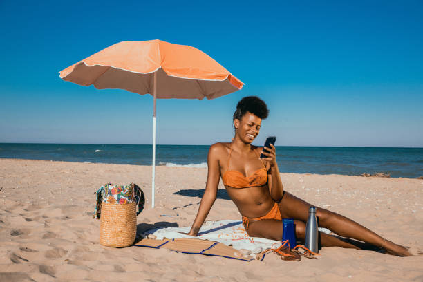istock Woman enjoying summertime at the beach 1310876844