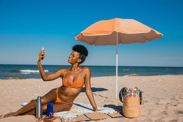 istock Woman enjoying summertime at the beach 1310876925