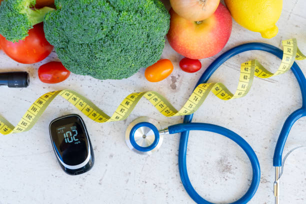 Diabetes healthy diet raw vegetables with blood glucose meter, lancet, measuring tape and stethoscope, diabetes healthy diet concept metabolic syndrome stock pictures, royalty-free photos & images