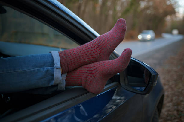 istock Woman feet in warm socks on car dashboard. 1310878496