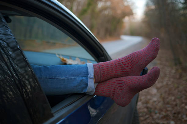 istock Woman feet in warm socks on car dashboard. 1310879561