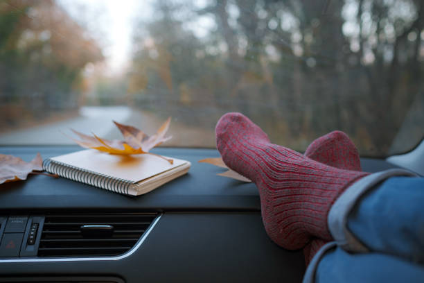 istock Woman feet in warm socks on car dashboard. 1310879693