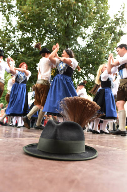 Traditional Austrian folk dance A hat on the stage of a public performance of a traditional Austrian folk dance at the farmers' market in Mondsee, Austria dirndl traditional clothing austria traditional culture stock pictures, royalty-free photos & images