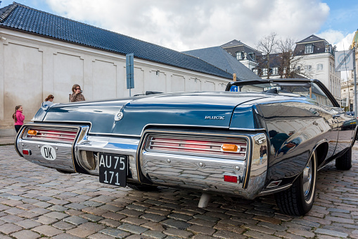 Copenhagen, Denmark - Oct 19, 2018: Close wide angle view of the rear design of a Buick car parked along Frederiksgade Street. The Buick badge occupies a unique place in American automotive history.