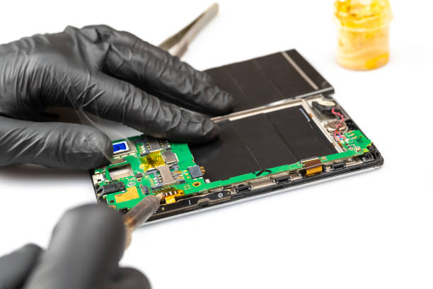 istock Close-up of electronics repairs. Electronics repair soldering of microchips and printed circuit boards in computer and electronic service. Shooting through a macro lens. 1310883629
