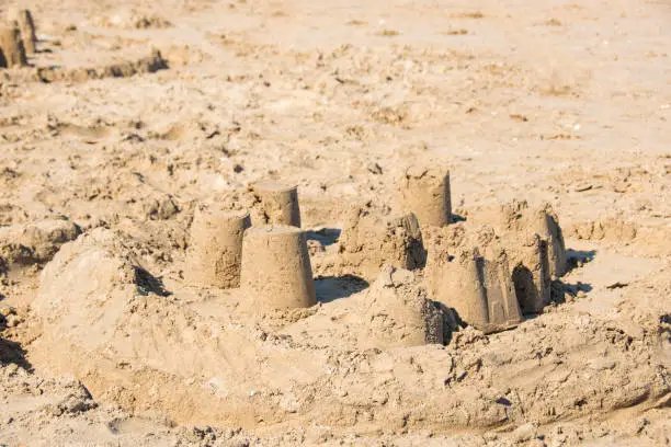 Sandcastle left to crumble alone on Bridlington South Beach, East Yorkshire, UK