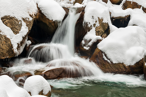 Front view of the waterfall in the winter season, ice and snow