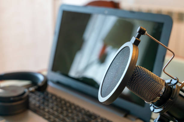 istock Podcast recording microphone in a home studio with a laptop computer and headphones 1310886999