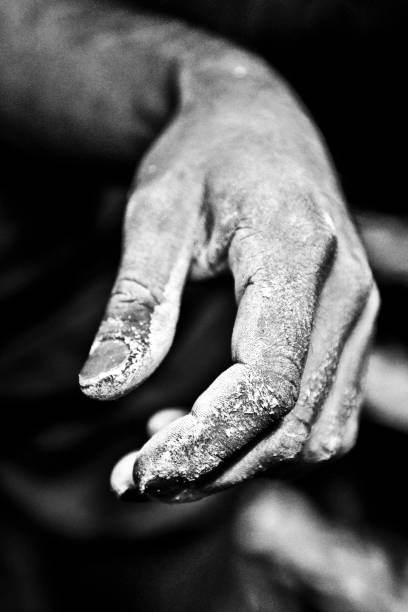 istock Climbing hand in magnesium, black and white. 1310888659