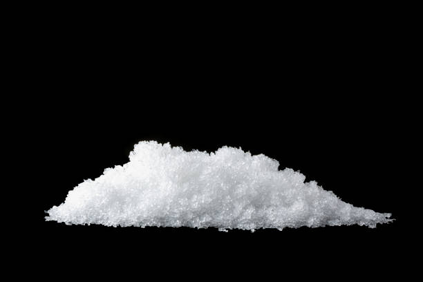 istock Heap of white snow isolated on black background 1310891230