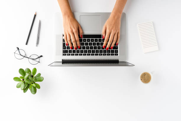 istock Woman’s hands working on laptop on white table with accessories. Business background. Flat lay 1310892516