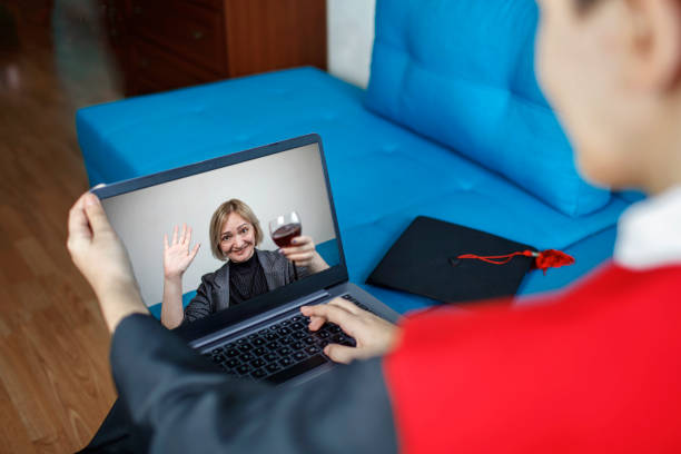 istock Virtual graduation ceremony. Student receiving congratulation from mother during online video call 1310894769