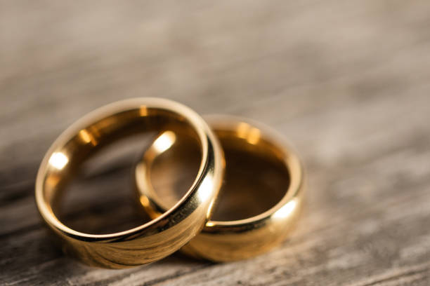 istock Golden wedding rings on wood 1310895547