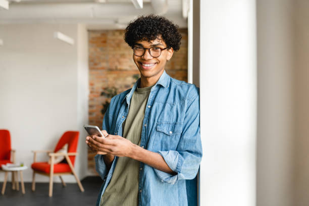 istock Smart young mixed-race businessman using phone at the workplace 1310895872