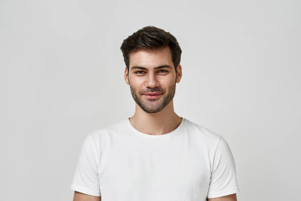 istock Bearded man in white t-shirt looking at camera 1310895882