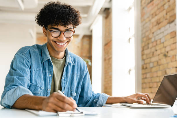 istock Confident young mixed-race businessman working at the office desk 1310895910